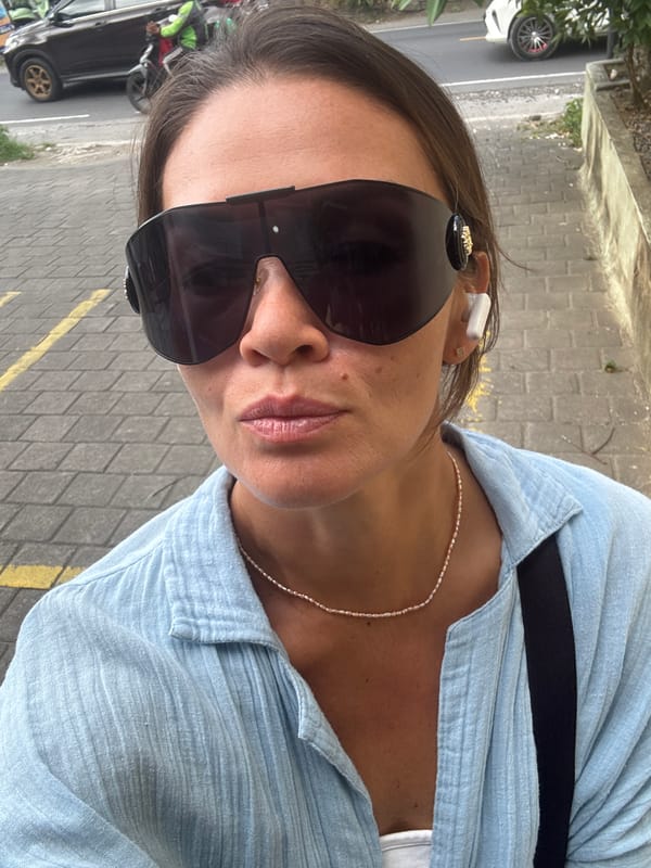 Sunny selfie in Kuta Selatan with shades and earbuds