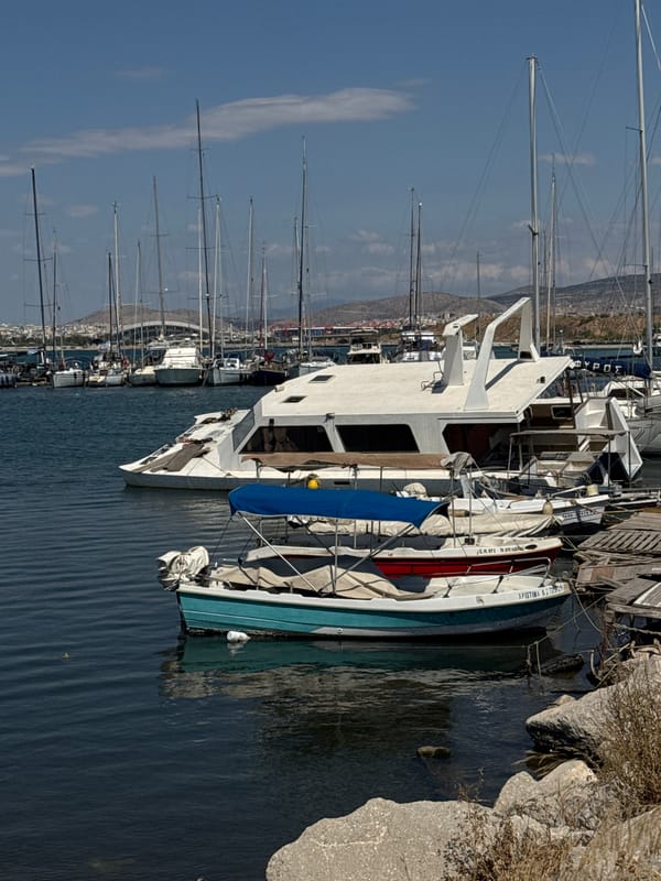 Sailboats moored at a sunny Piraeus marina, July morning