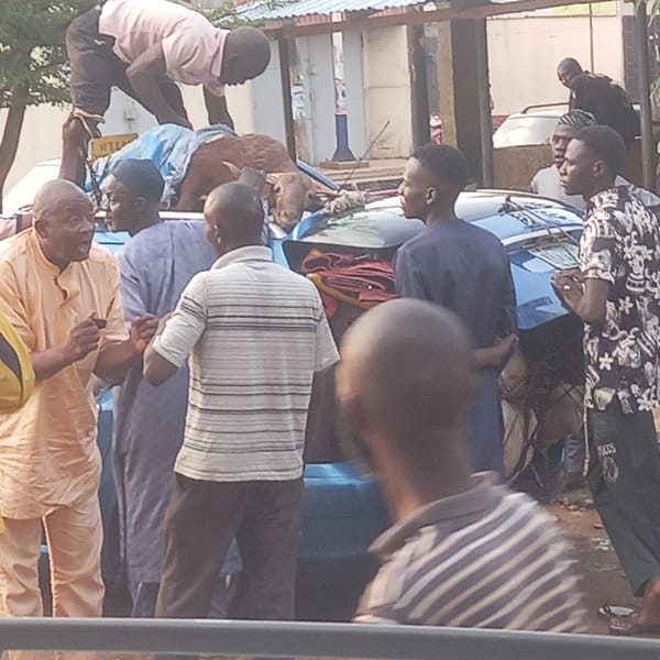 Men gather around loaded vehicle with goat in Dadi Riba