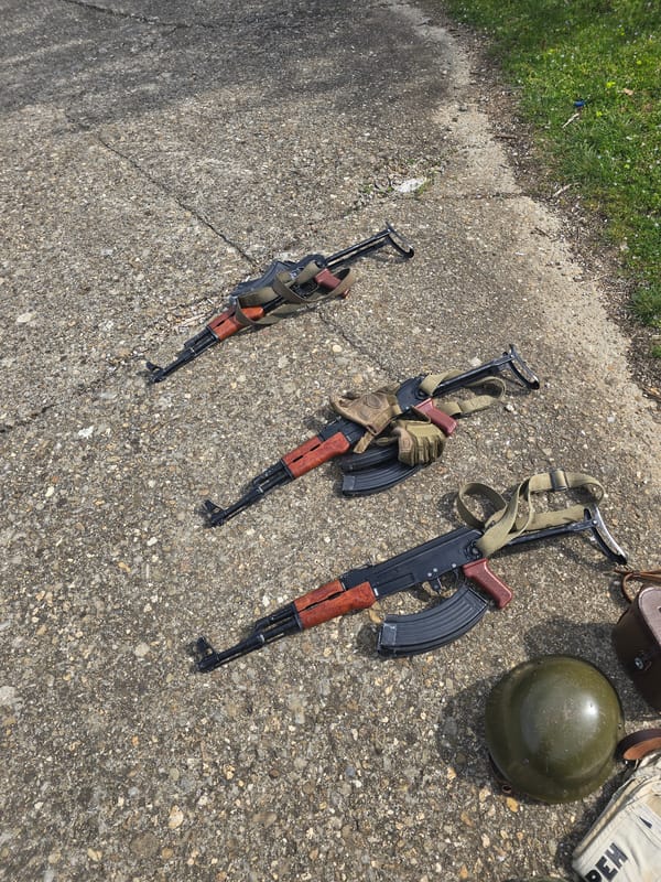 Three AK-47 rifles displayed on concrete in Bulgarian town