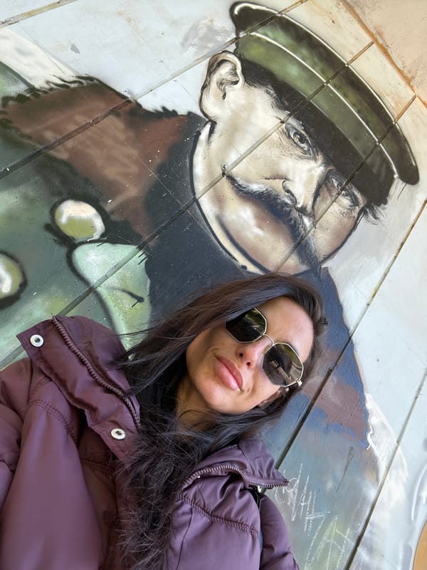 Woman photographs morning walk near historical murals in Pleven