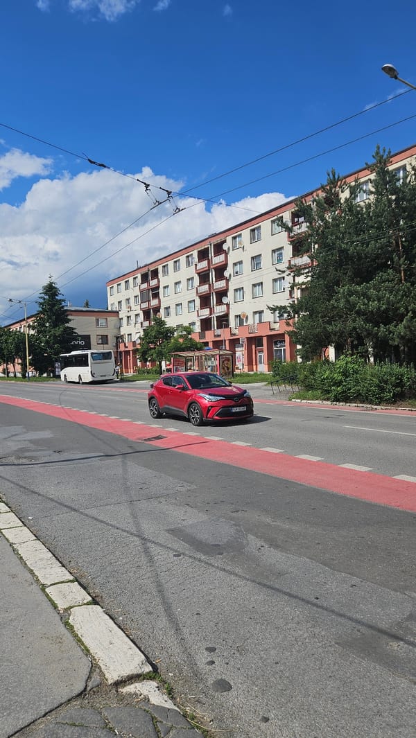 Red Toyota observed on Prešov street amid sunny afternoon