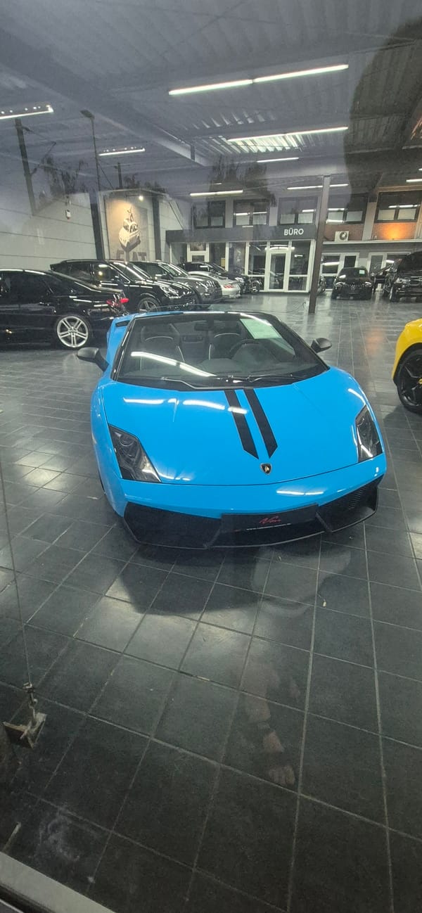Exotic cars on a showroom floor, Mainz at dusk