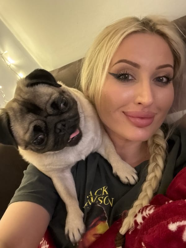 Couch hangout with a shoulder-riding, tongue-out pug