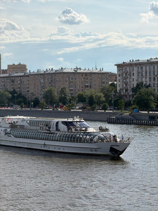 Passenger boats cruise Moscow River near Peter Great monument
