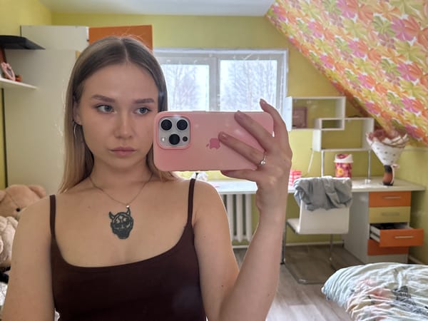 Woman takes selfie in yellow-walled room in Zhigalki, Russia