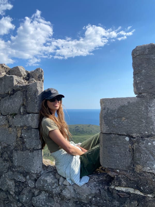 Tourist photographs herself at historic ruins in Montenegro