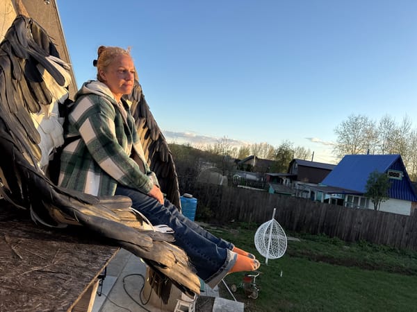 Casual backyard activities documented in Chaikovsky, Russia during afternoon