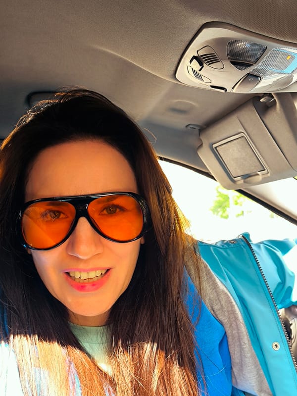 Woman takes morning selfies in car in Riga