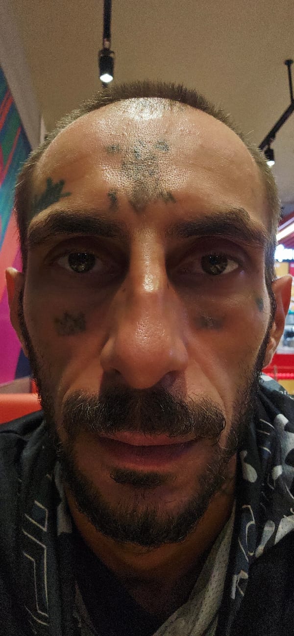 Tattooed man eats at Jollibee restaurant in Vietnam