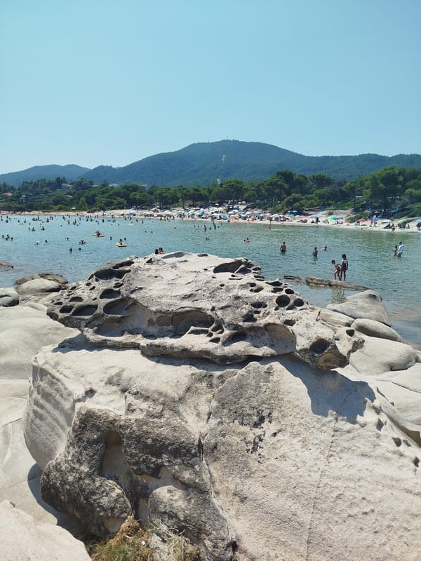 Sithonia's rocky shoreline on a busy summer morning