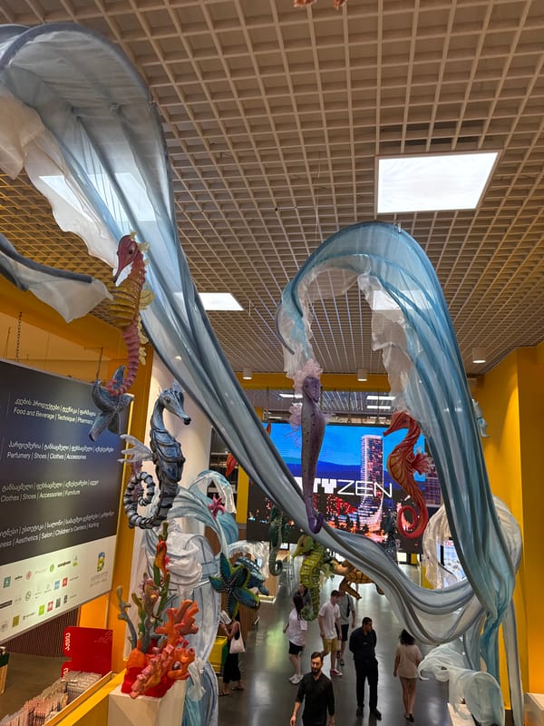 Indoor art installation and street-parked scooters, same morning
