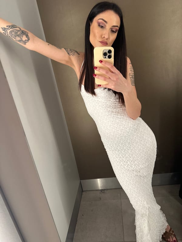 Woman takes selfie in dressing room mirror