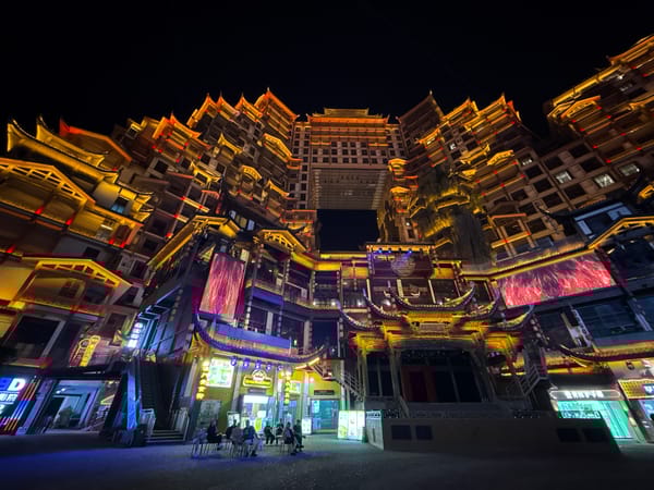 Illuminated traditional-modern architecture complex observed in nighttime Zhangjiajie