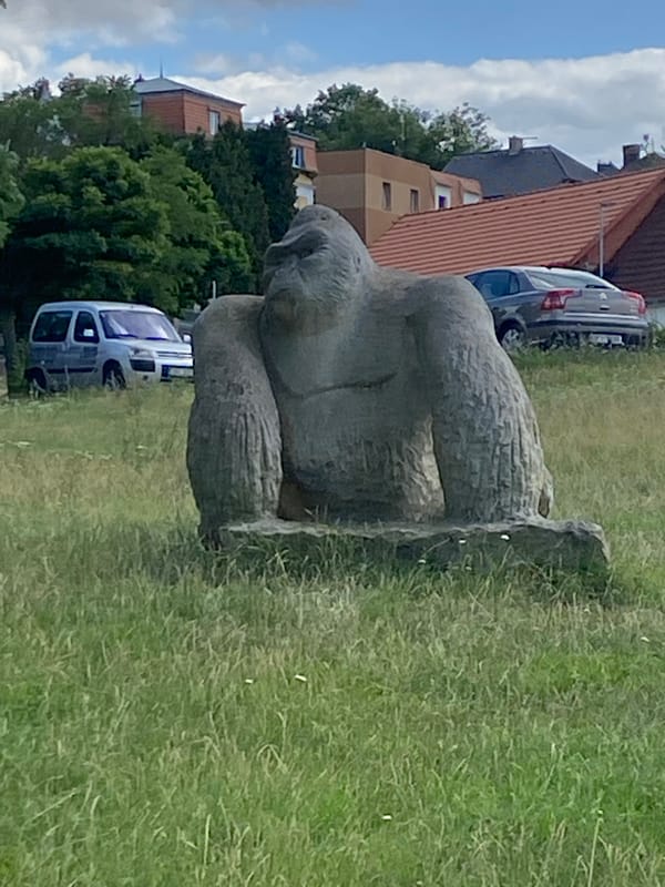 Stone animal sculptures scattered across a park in Bílina