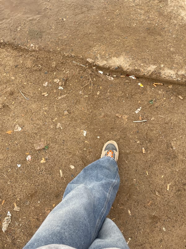 Woman observed on littered sidewalk in Ольховка, Russia