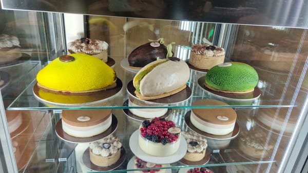 Pastry display in a Taranto bakery, fresh berry cake on show