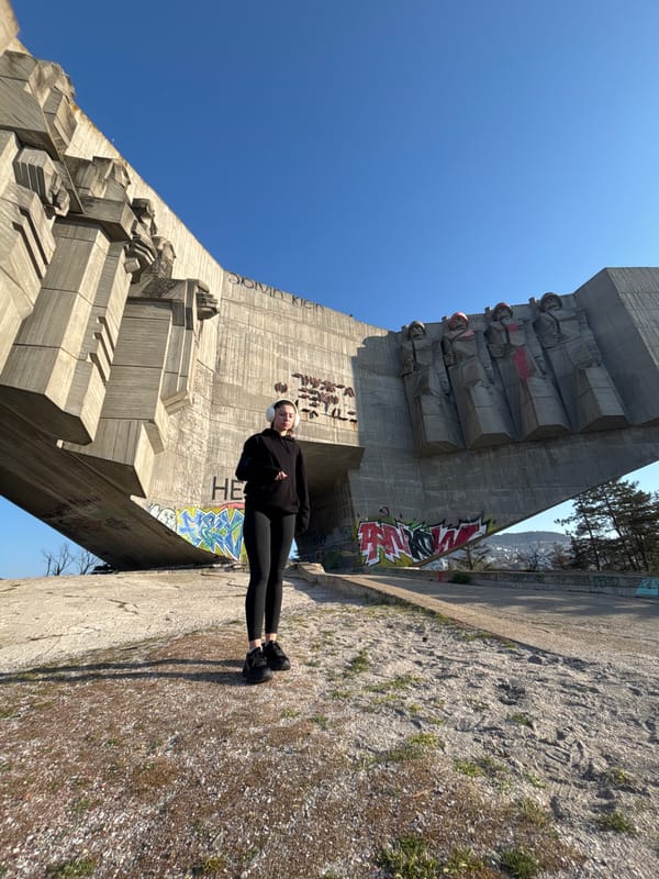 Person performs morning yoga on urban concrete monument