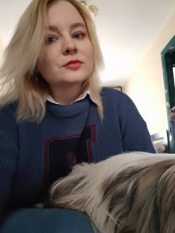 Woman takes selfies with small dog during morning photo session