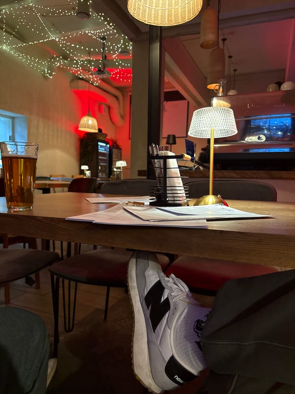 Beer and menu captured at Moscow restaurant table