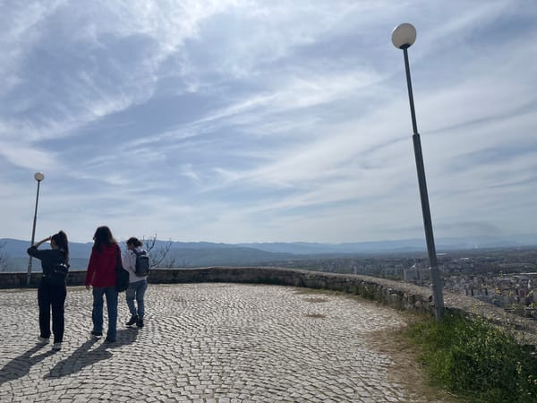 Three people walk scenic Plovdiv overlook terrace