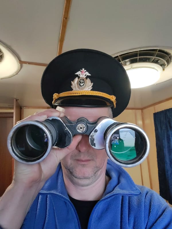 Ship observer watches cargo vessel navigate Russian waterway
