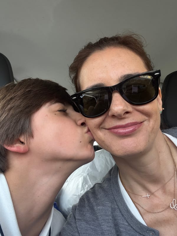 Woman kisses child in indoor Porto location