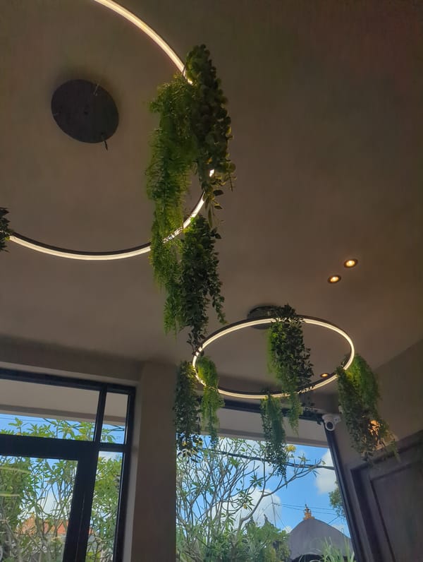 Green-adorned LED fixtures observed in dimly lit Mengwi interior