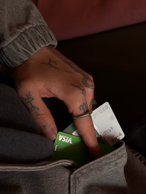 Tattooed individual documents credit card handling, selfies in Yerevan