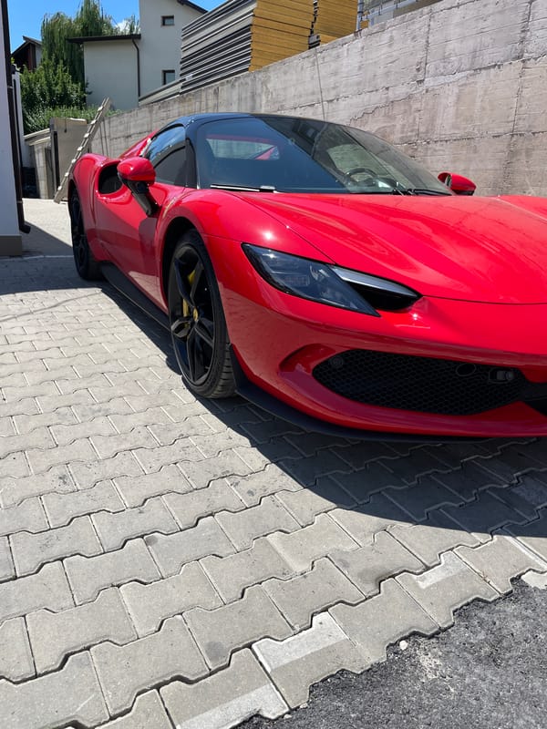 Red Ferrari parked outside, shot from two angles