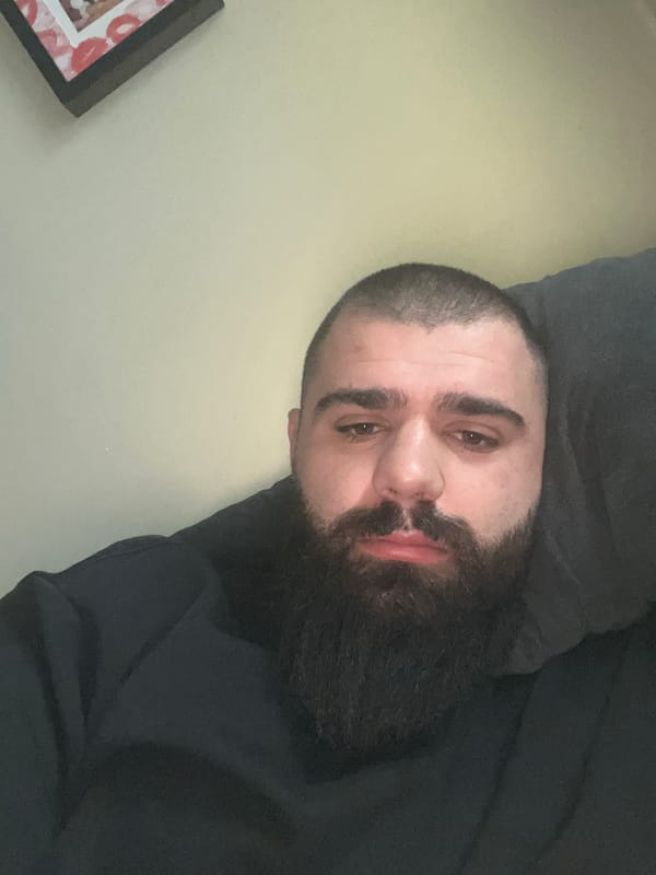 Man resting on cushion photographed in Dobrich apartment