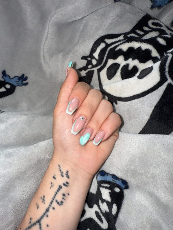 Hand with French manicure rests on Stitch blanket in Bulgaria
