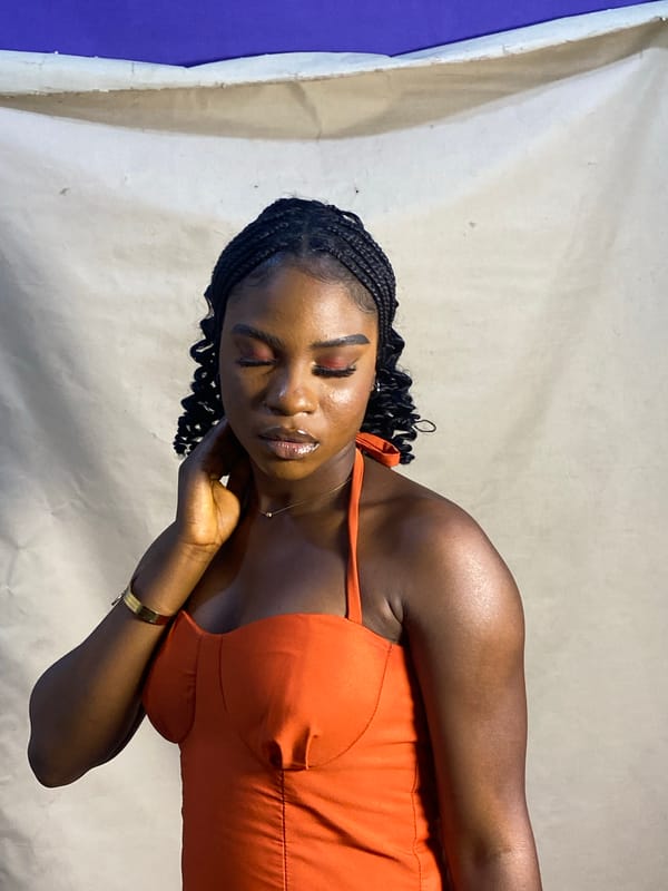 Woman poses for photo shoot in orange dress, Jos Nigeria