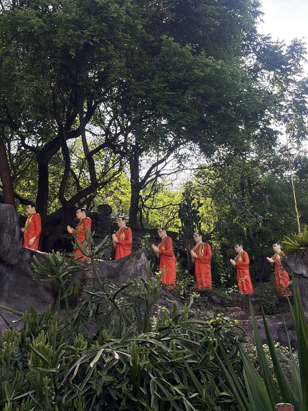 Monk statues in orange robes observed on Dambulla rock formation