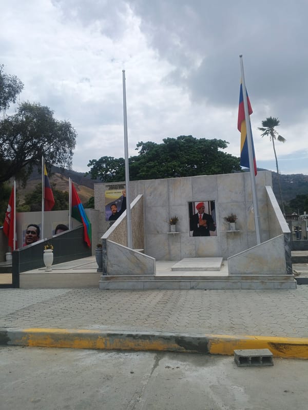 Visitors document memorials at Caracas cemetery including recent heroes mausoleum
