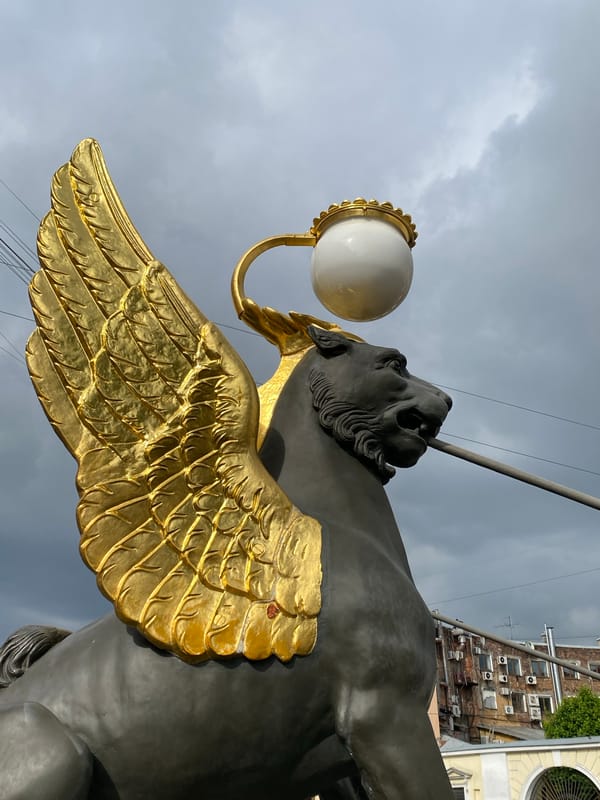 Tourist documents Saint Petersburg's Bank Bridge griffin statues and architecture