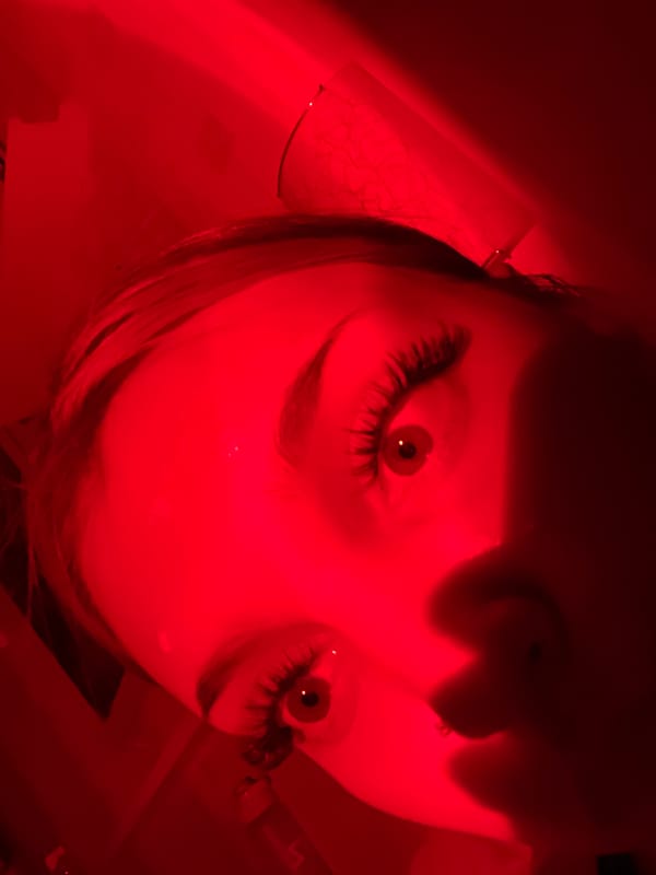Red-lit portrait session documented in Russia
