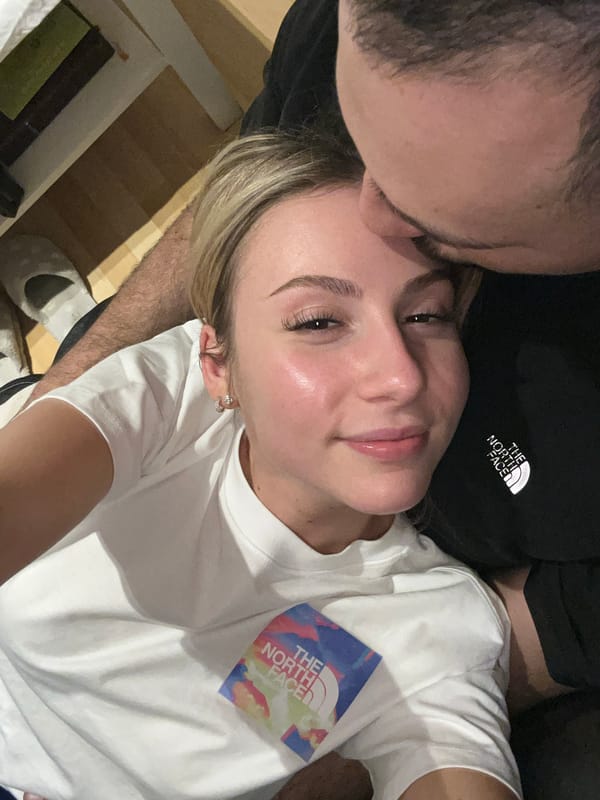 Couple shares intimate moment indoors, photographed together