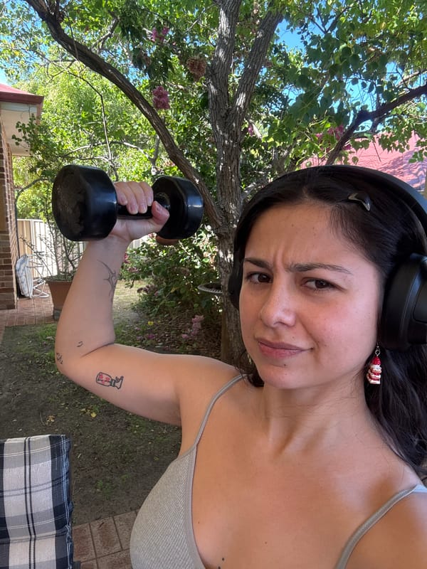 Woman exercises with dumbbells outdoors in Como, Australia