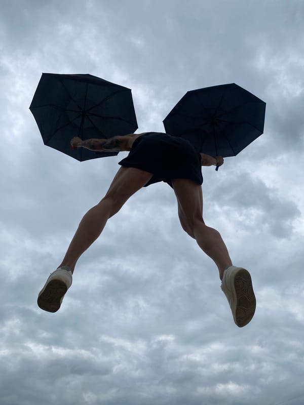 Person photographed jumping with two umbrellas in Pleven