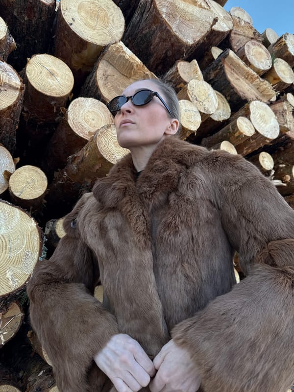 Woman poses for outdoor photoshoot at Russian lumber yard