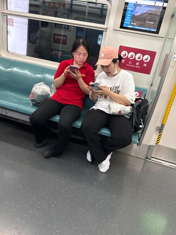 Passengers on phones aboard a Daxing District subway