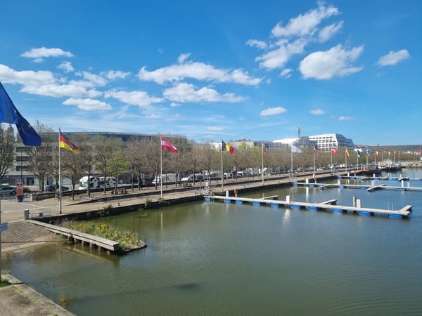 International flags displayed at Nancy marina on sunny day