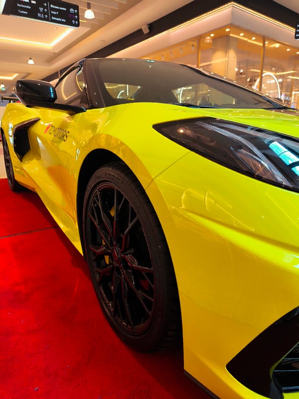 Corvette C8 and luxury branding at a Riga indoor event