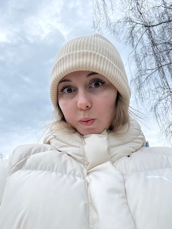 Woman documents urban walk through overcast city streets