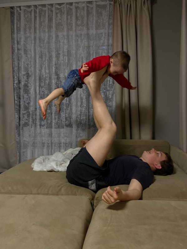 Adult and child captured playing on couch in Ольховка