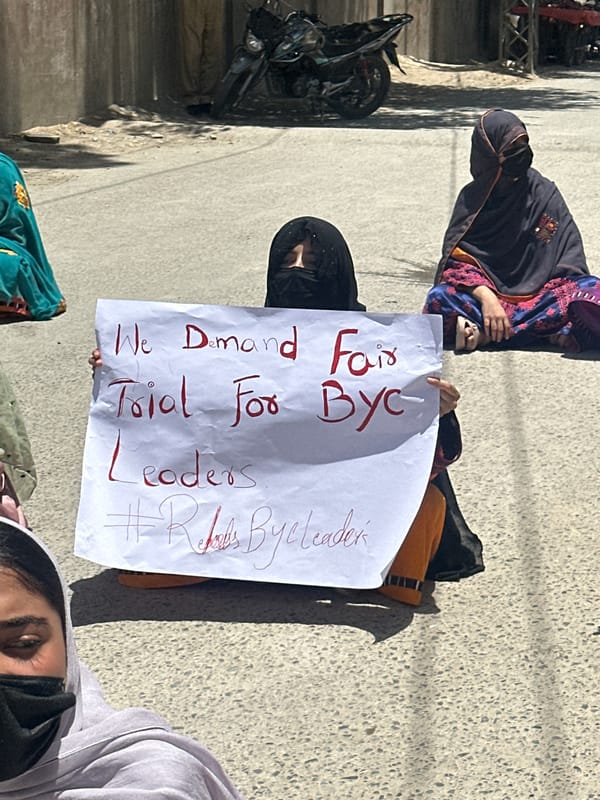 Sit-in protest in Quetta with signs demanding justice