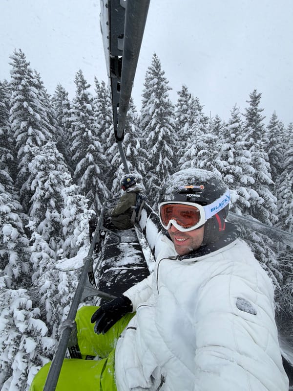 Skier takes selfies on lift during snowfall in Les Allues