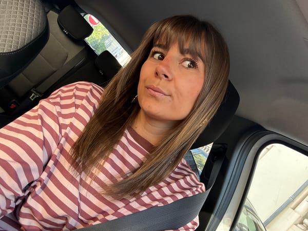 Woman in striped shirt observed in car during early morning Cannes street scene