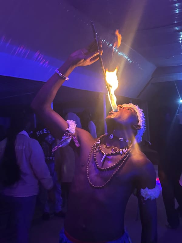 Late-night fire performance and dancing at a Wumat venue